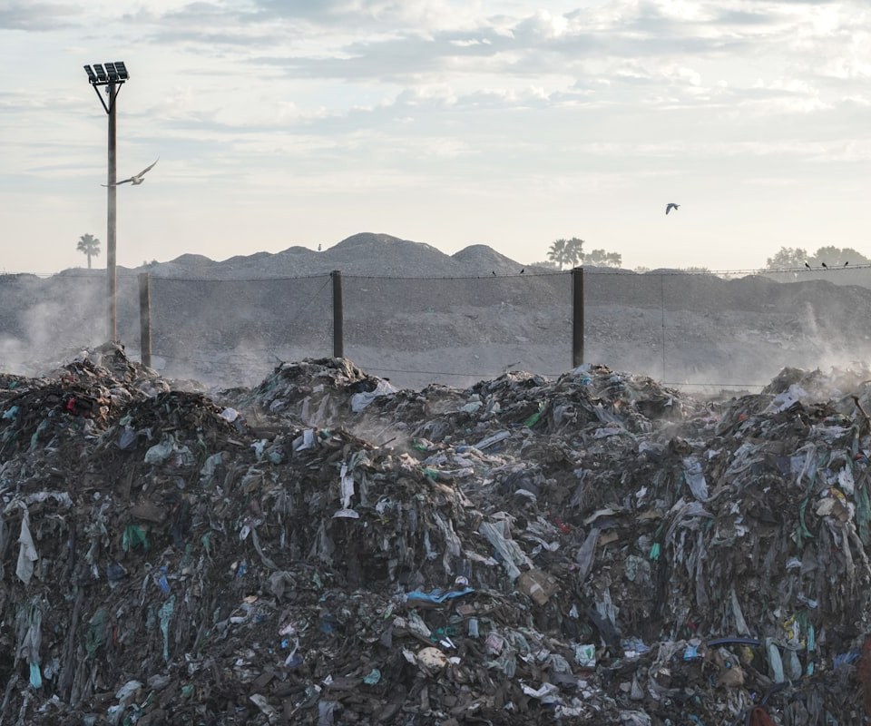 Landfill with vapour rising near a community boundary